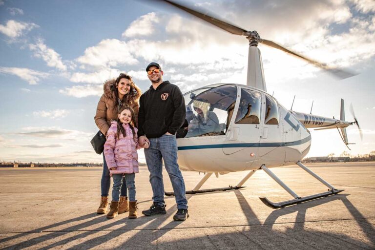 Family posing in front of tour helicopter