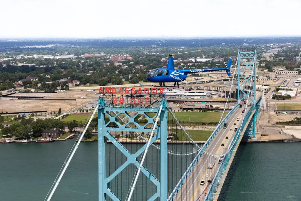 a myflight tours helicopter flying over the ambassador bridge in detroit MI