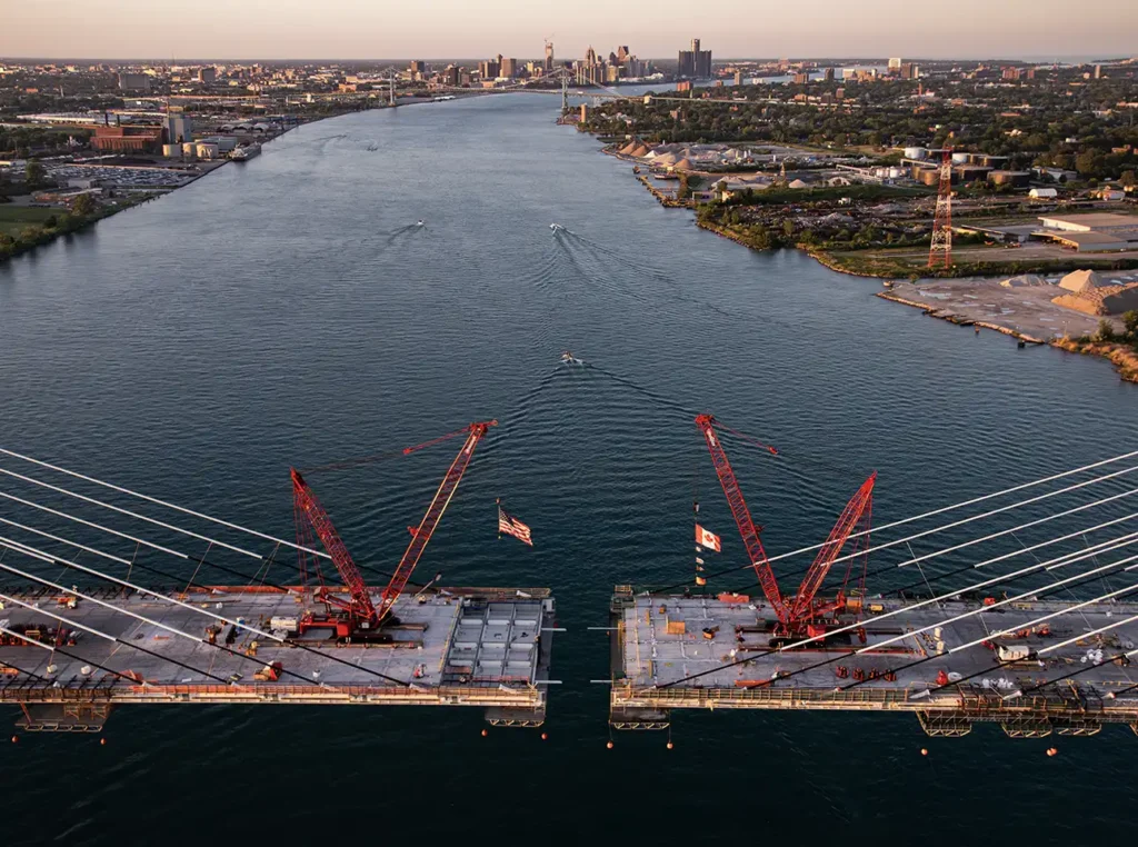 the building of the gordie howe bridge in detroit from a helicopter