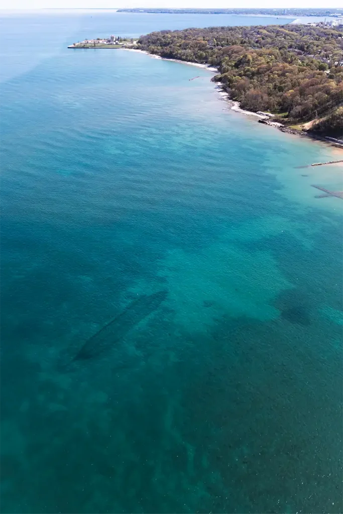 White Fish Bay in Milwaukee taken from a helicopter with the outline of a sunken ship